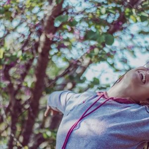 smiling woman wearing grey pullover hoodie